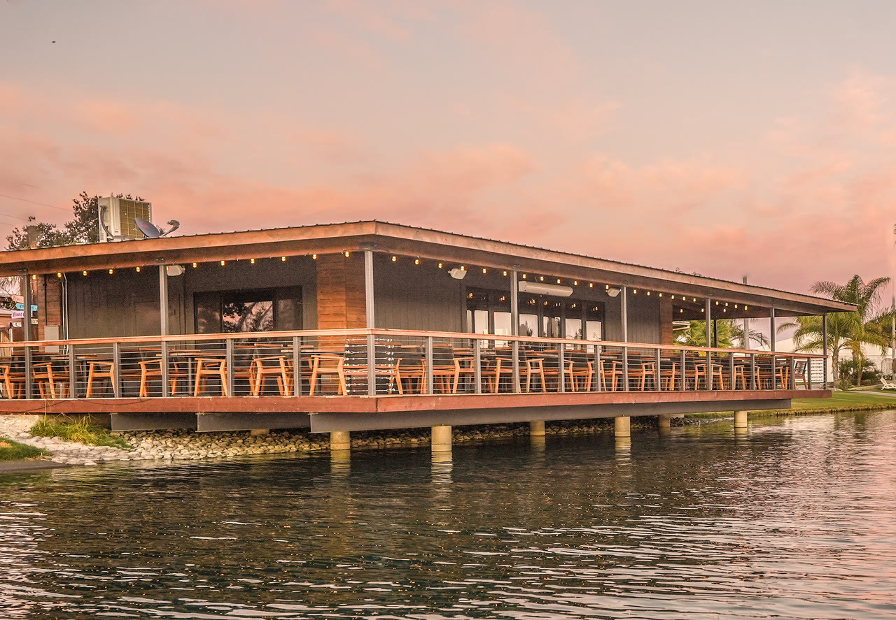 The restaurant standing on pilings over the lake at sunset