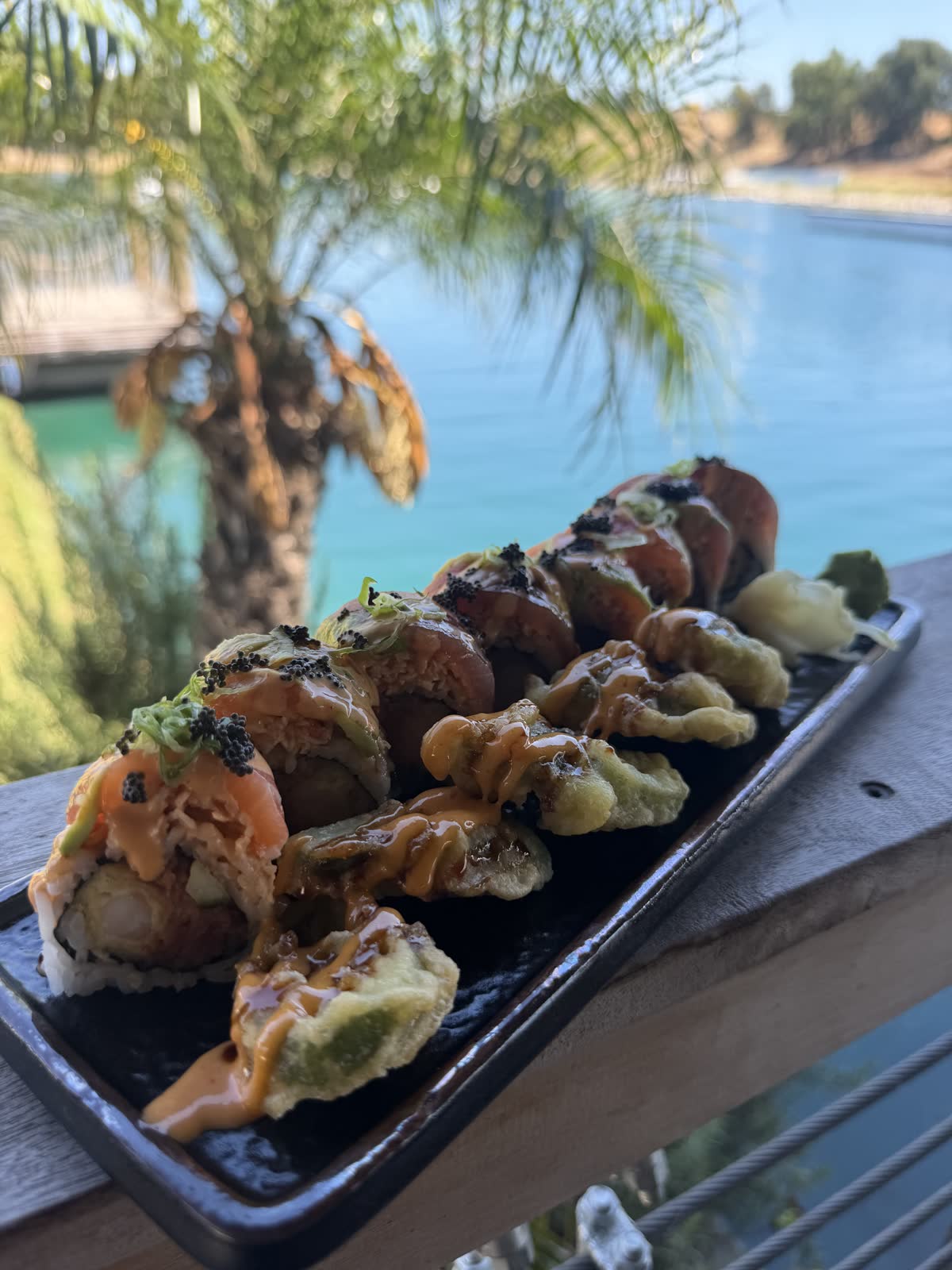 Salmon roll in golden light with palm and lake bokeh